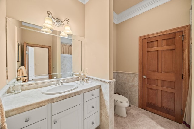 bathroom with tile walls, vanity, ornamental molding, tile patterned floors, and toilet