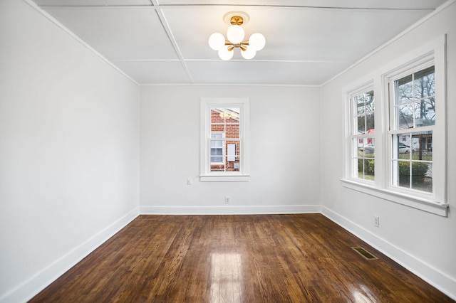 empty room featuring baseboards, visible vents, ornamental molding, dark wood-type flooring, and a notable chandelier