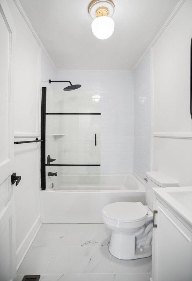 full bathroom featuring vanity, crown molding, toilet, and tiled shower / bath