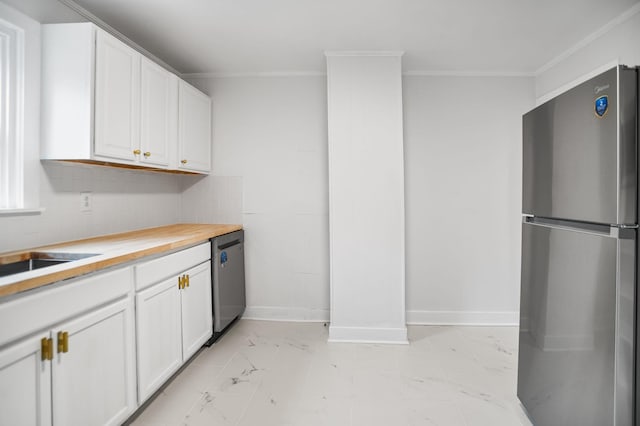 kitchen with stainless steel appliances, white cabinetry, ornamental molding, and wooden counters