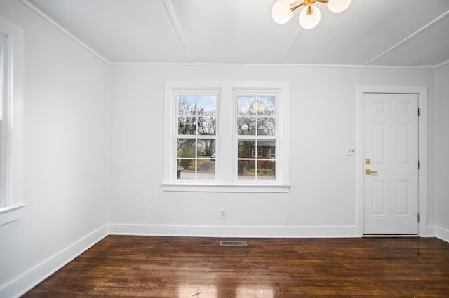 empty room featuring visible vents, baseboards, and dark wood-style flooring