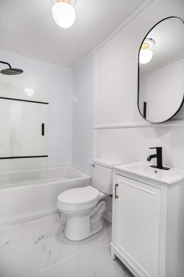 full bathroom with vanity, ornamental molding, toilet, and tiled shower / bath