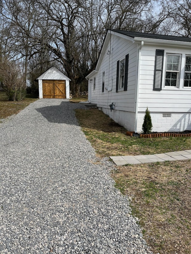 view of home's exterior with an outbuilding and crawl space