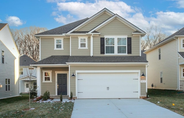 view of front of house featuring a garage and a front yard