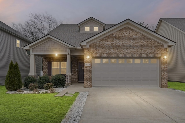 view of front of home featuring a garage and a lawn