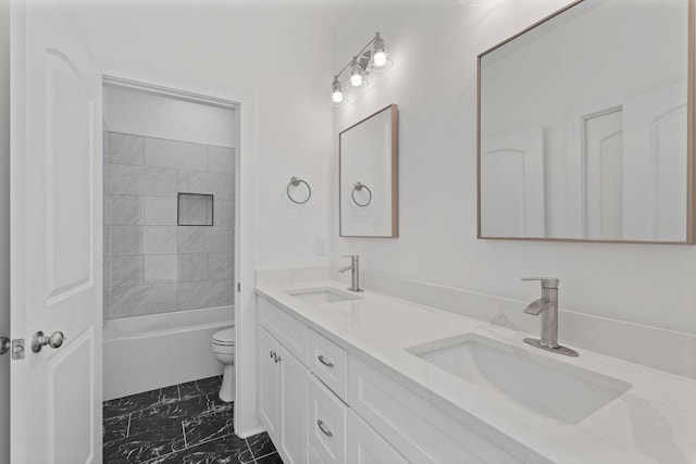 full bathroom featuring vanity, tiled shower / bath, and toilet