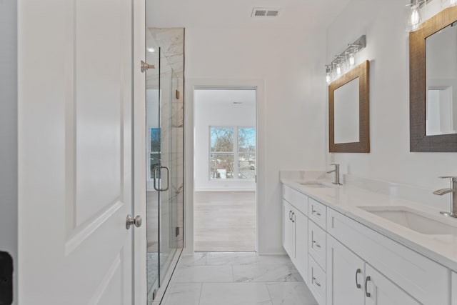 bathroom featuring vanity and a shower with door