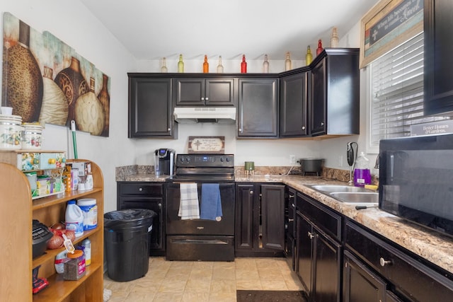 kitchen with lofted ceiling, sink, light stone counters, and black appliances