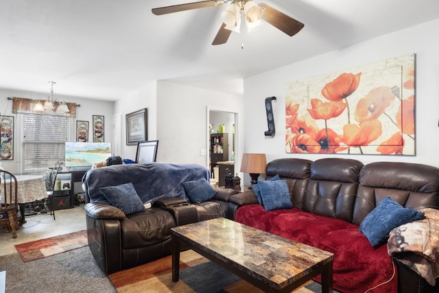 carpeted living room with ceiling fan with notable chandelier