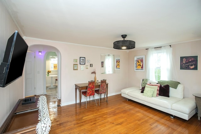 living room with ornamental molding and hardwood / wood-style floors