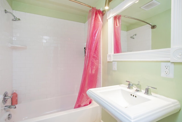 bathroom with sink and shower / tub combo with curtain