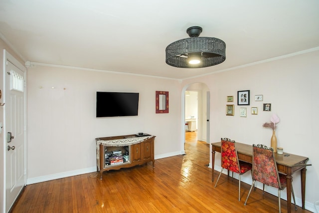 dining area featuring ornamental molding and wood-type flooring