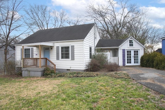 view of front of home featuring a front yard and french doors