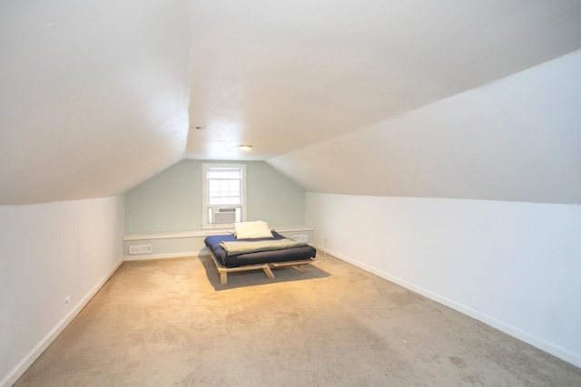 unfurnished bedroom featuring cooling unit, light colored carpet, and lofted ceiling