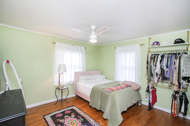 bedroom featuring crown molding, ceiling fan, and dark hardwood / wood-style flooring