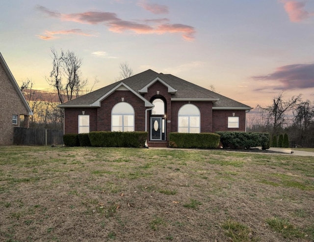 ranch-style home featuring a yard