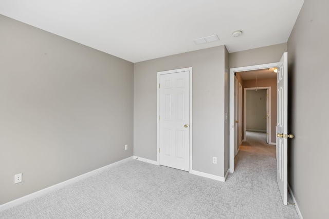 unfurnished bedroom featuring light colored carpet