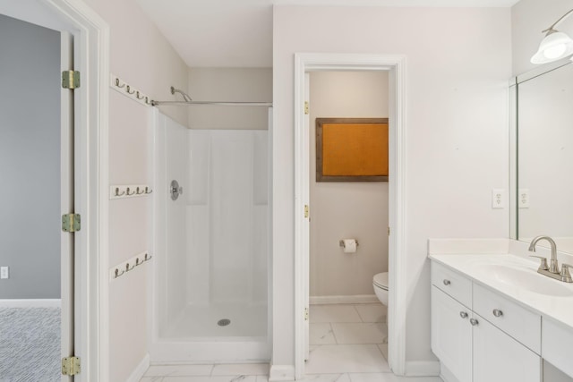 bathroom featuring vanity, a shower, and toilet