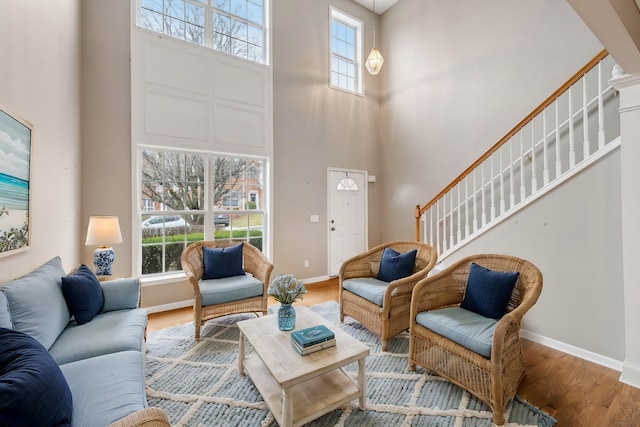 living room featuring hardwood / wood-style flooring and a high ceiling