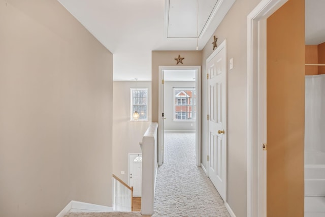 hall with light colored carpet