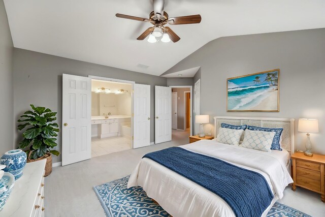 bedroom featuring vaulted ceiling, sink, connected bathroom, and ceiling fan