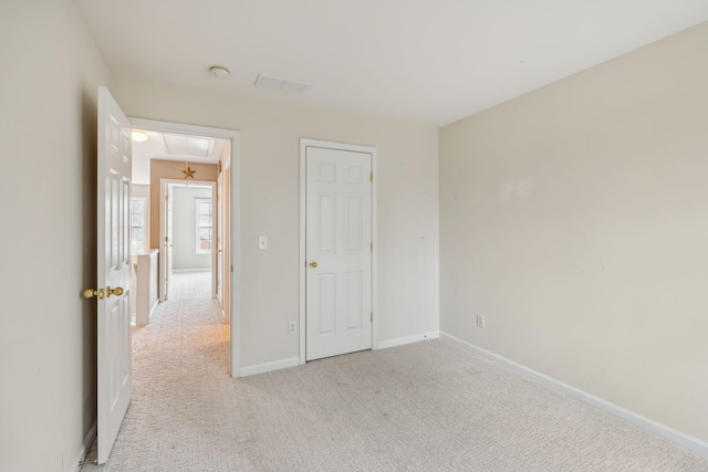 unfurnished bedroom featuring light carpet