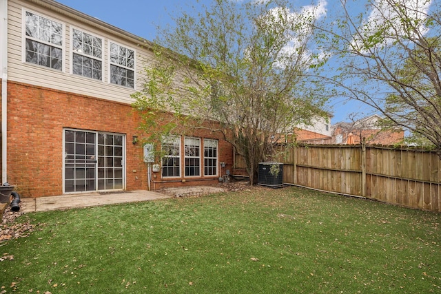 rear view of house featuring a yard and central AC