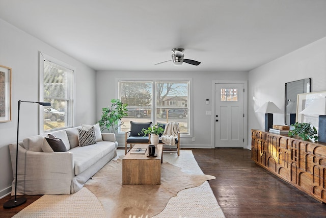 living room featuring ceiling fan and dark hardwood / wood-style flooring