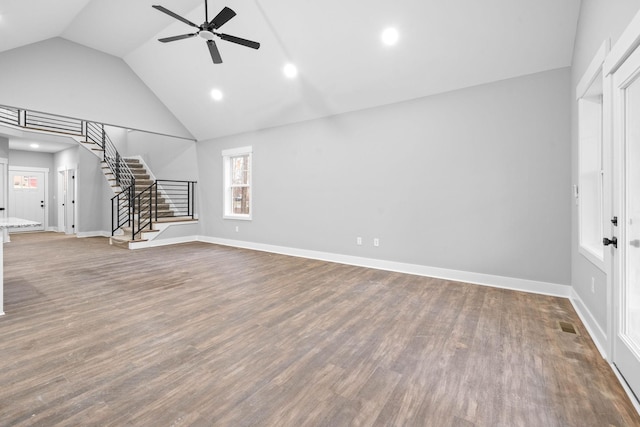 unfurnished living room with hardwood / wood-style floors, high vaulted ceiling, and ceiling fan