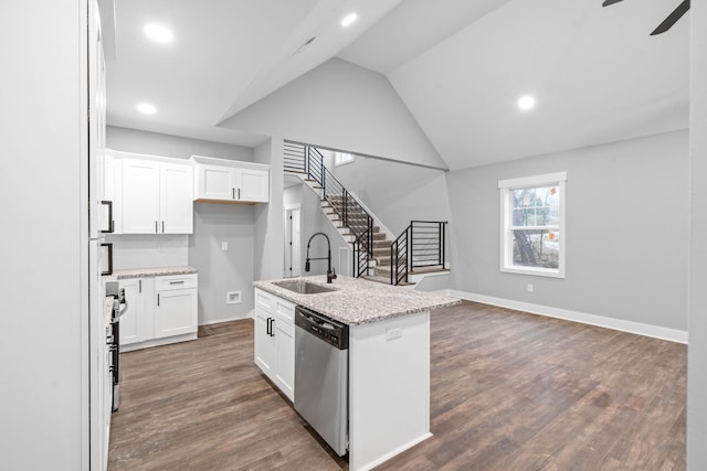 kitchen featuring dishwasher, sink, light stone countertops, and white cabinets