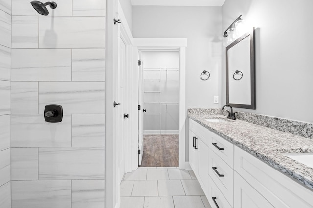 bathroom featuring vanity and tiled shower