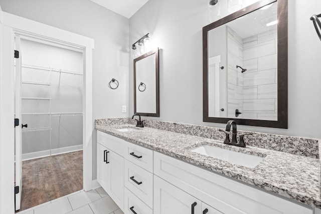 bathroom with vanity and a shower