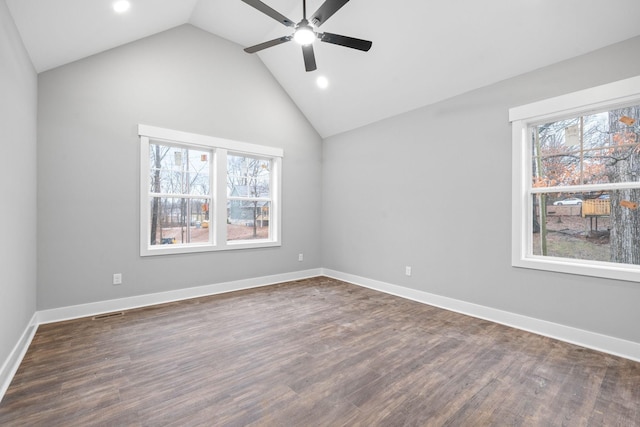 empty room with ceiling fan, lofted ceiling, dark hardwood / wood-style flooring, and a wealth of natural light