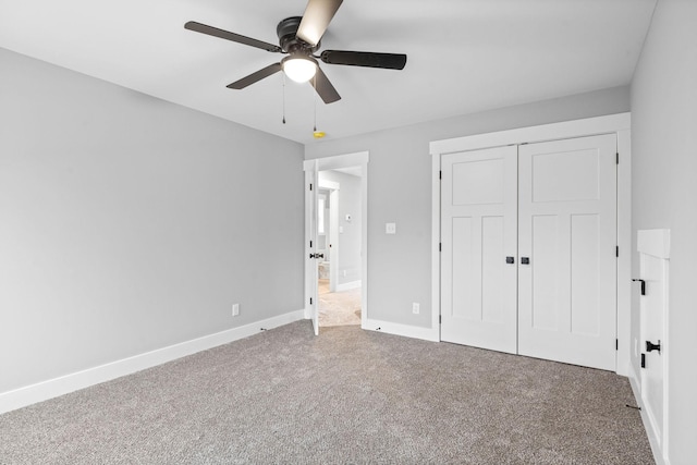 unfurnished bedroom with ceiling fan, carpet flooring, and a closet