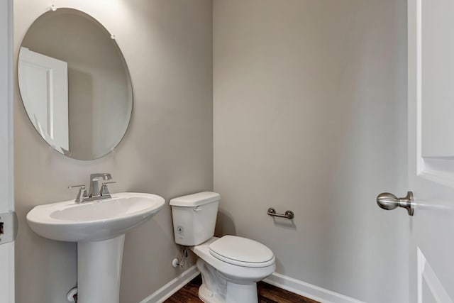 bathroom with wood-type flooring and toilet