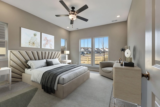 bedroom featuring light colored carpet and ceiling fan