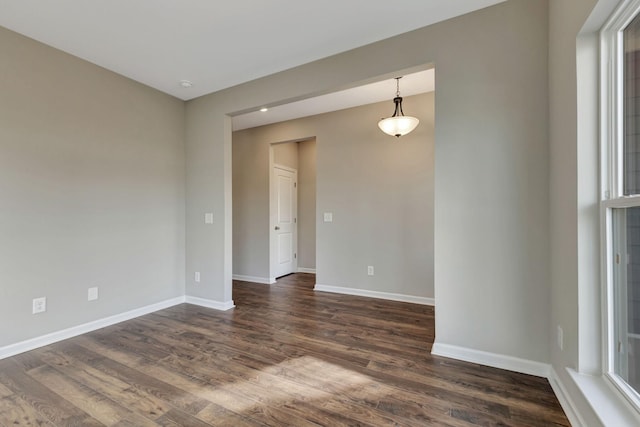 spare room with dark wood-type flooring