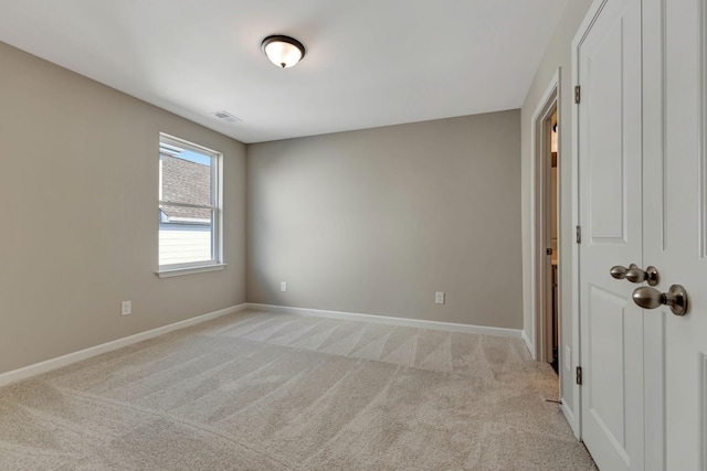 empty room featuring light carpet