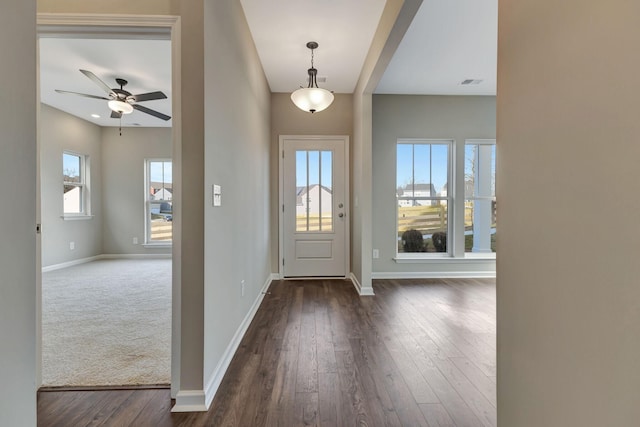 foyer entrance featuring dark wood-type flooring and ceiling fan