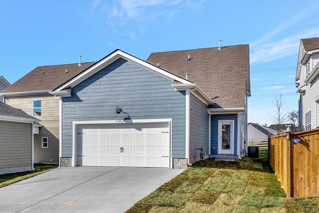 back of property featuring central AC, a yard, and a garage