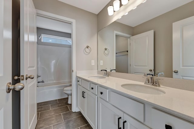 full bathroom featuring vanity,  shower combination, and toilet