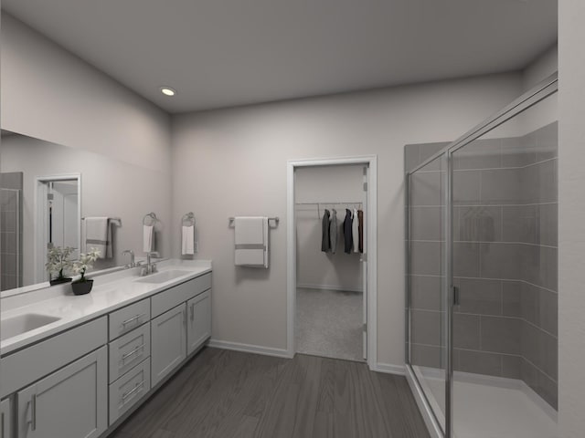 bathroom with walk in shower, vanity, and hardwood / wood-style flooring