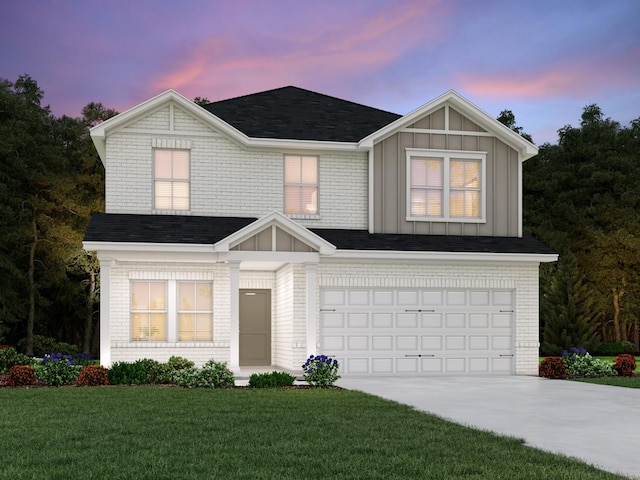 view of front of home with a garage and a lawn