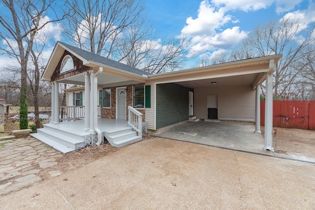 view of front of home with a carport and covered porch