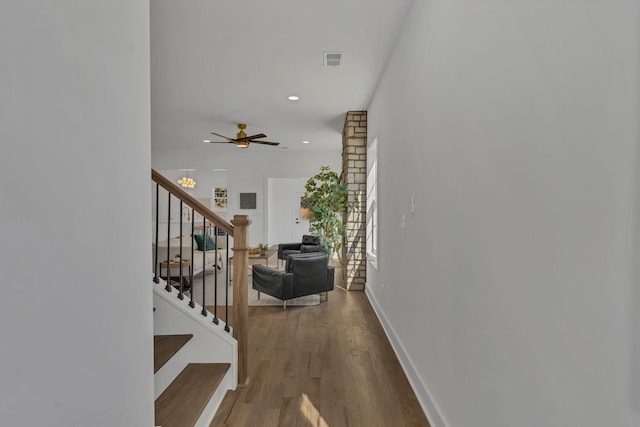 corridor with hardwood / wood-style flooring