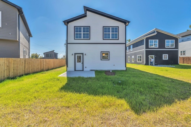 rear view of house with a yard and a patio