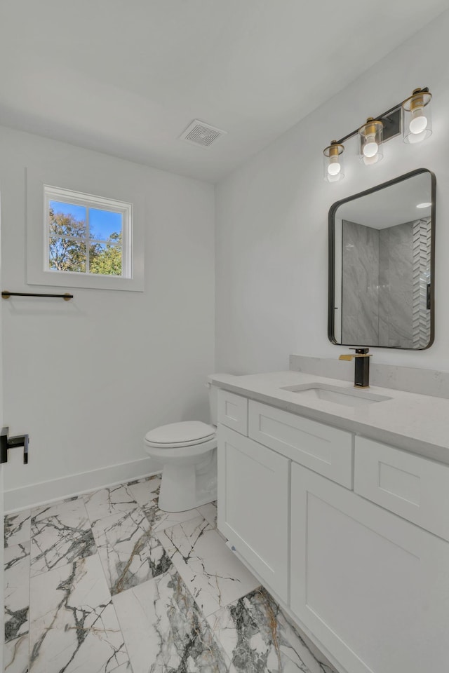 bathroom with walk in shower, vanity, and toilet