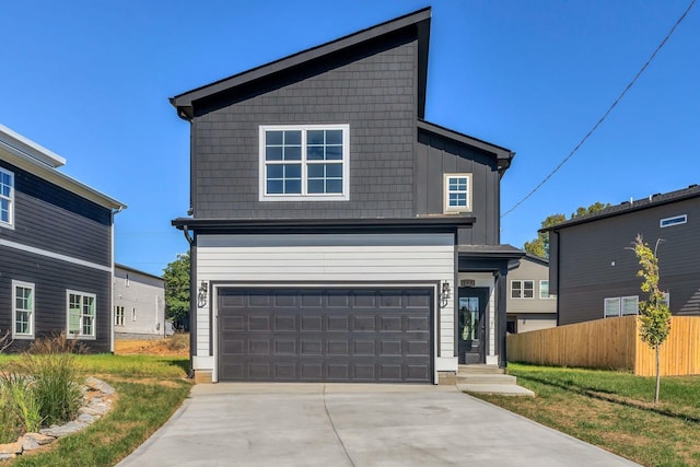 view of front property with a garage and a front lawn