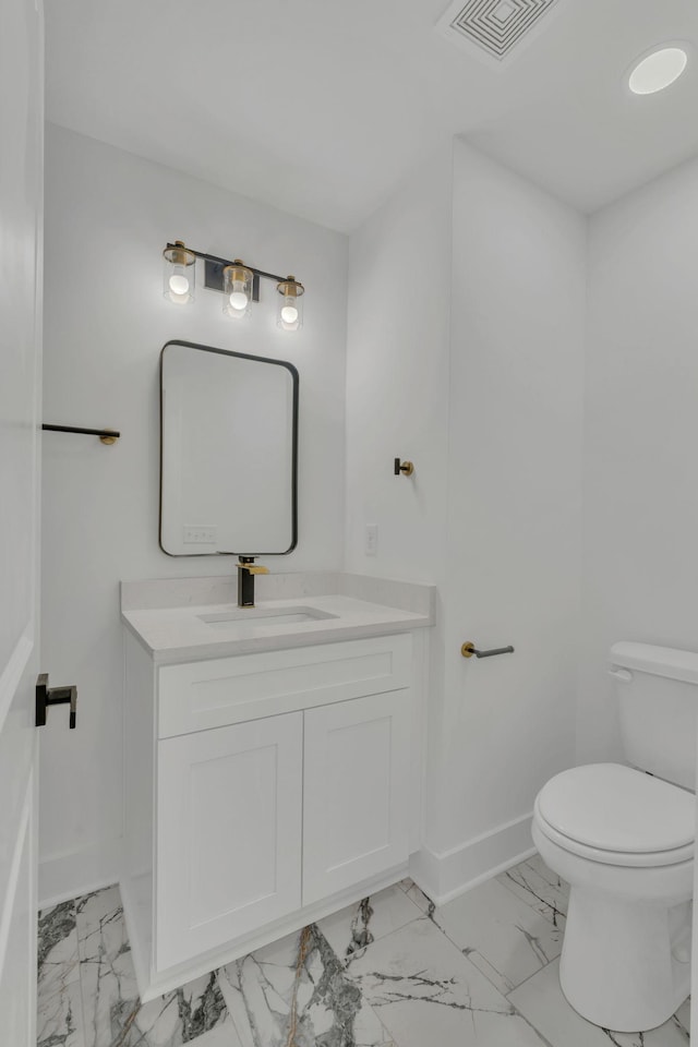 bathroom with vanity and toilet