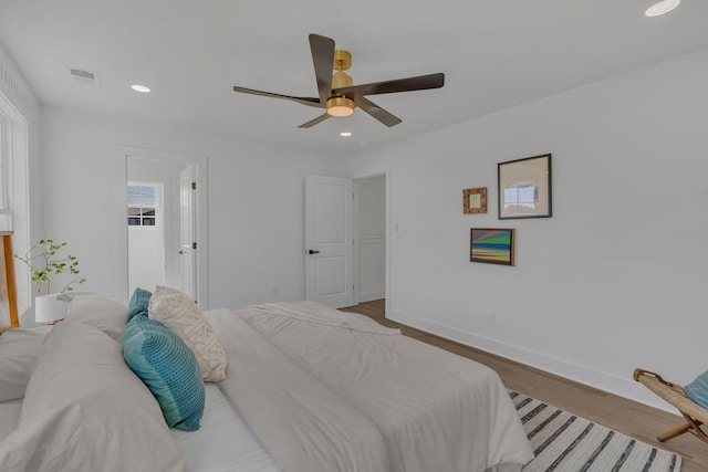 bedroom with ceiling fan and light hardwood / wood-style flooring